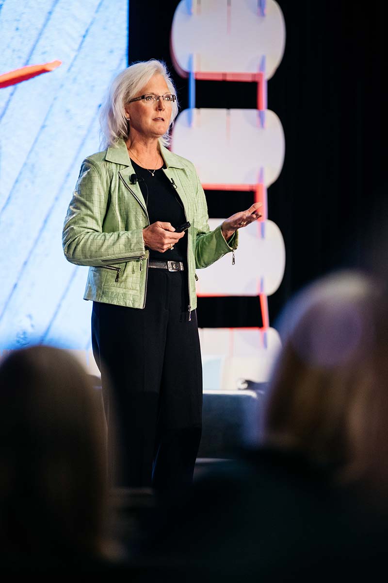 A photograph of Nancy M. Dahl speaking from stage