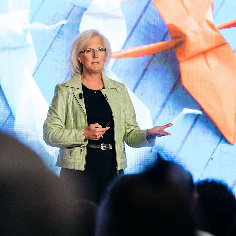 A phototgraph of Nancy M. Dahl speaking from Stage